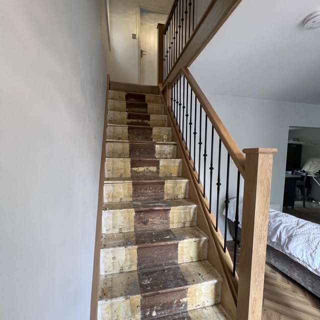 Staircase mid-renovation with stripped carpet